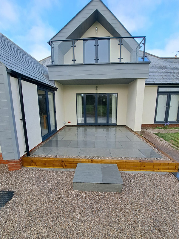 Raised side patio in stone flags